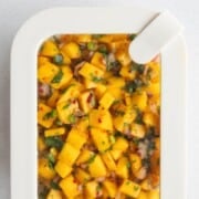 Mango salsa in a meal prep container.