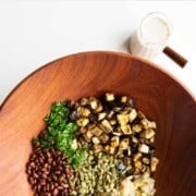 Pickle juice salad dressing with eggplant salad in a bowl.