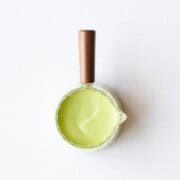Creamy oil-free pumpkin seed dressing in a glass pouring container.