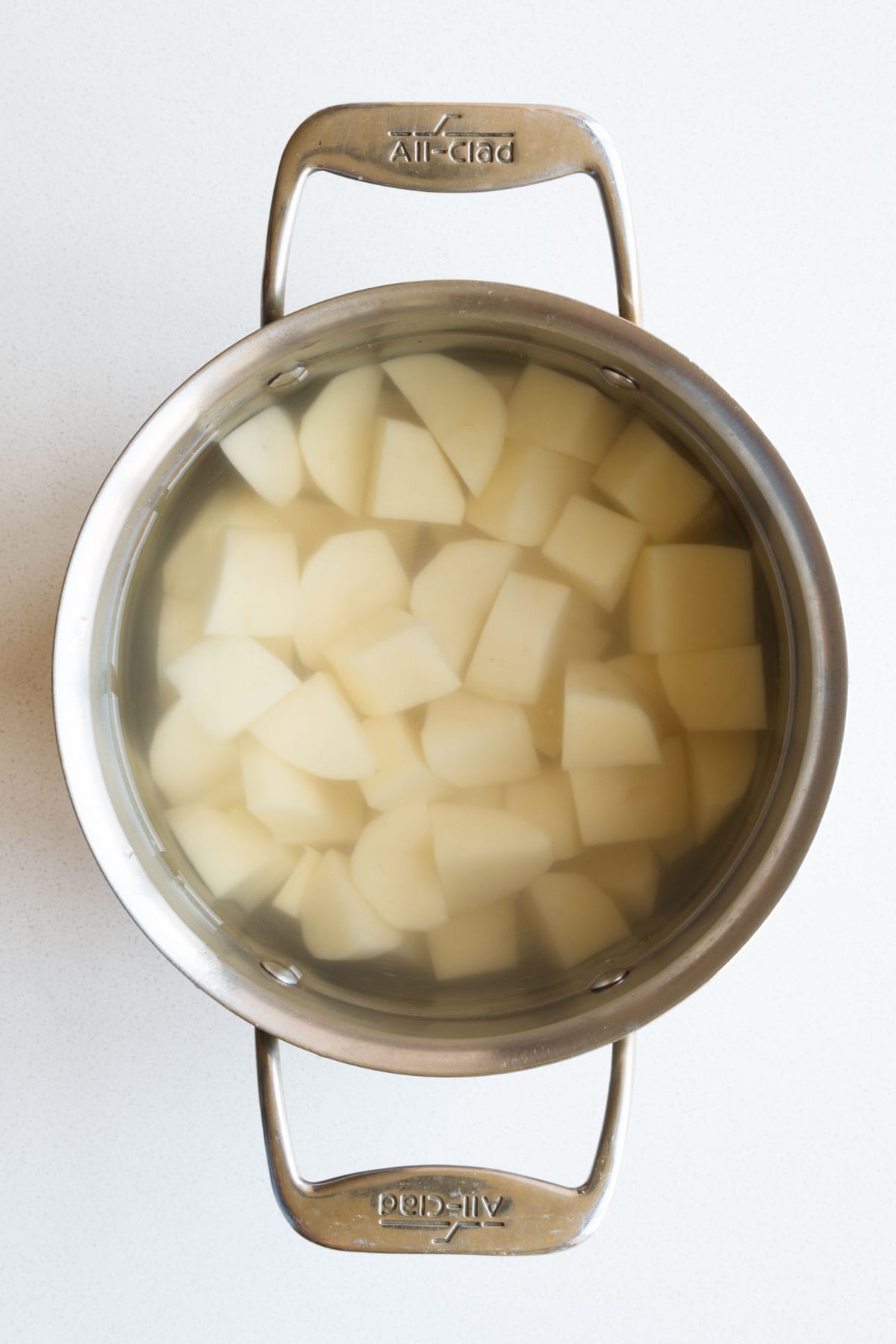 Chopped potatoes simmering in water.