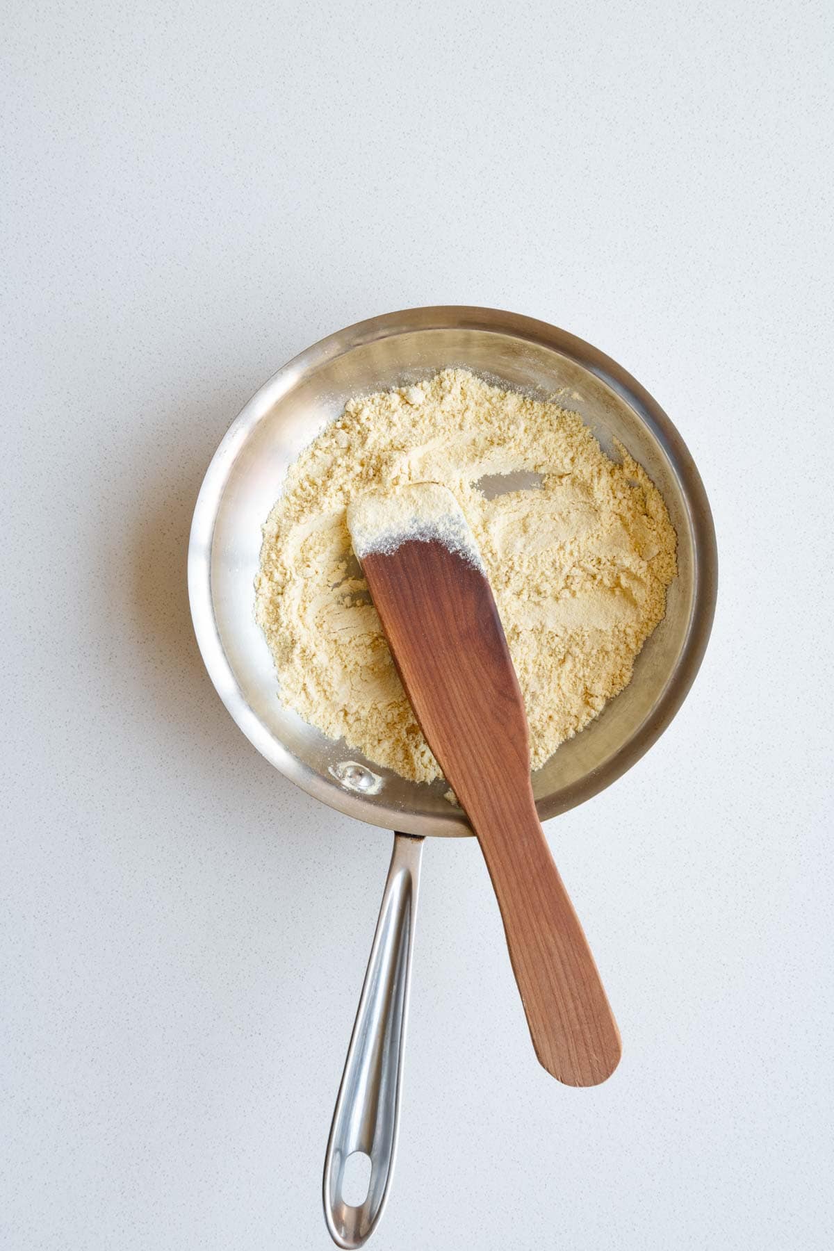 Toasted chickpea flour in a skillet.