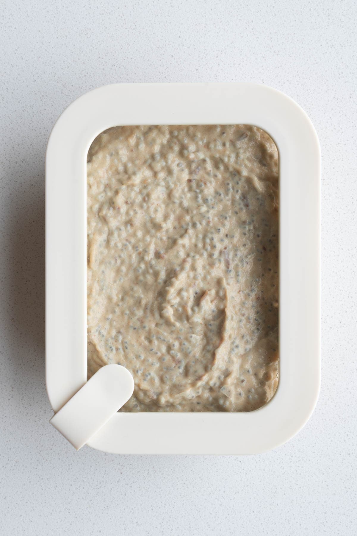 Chia Seed Peanut Butter Pudding in a glass dish covered for refrigeration.