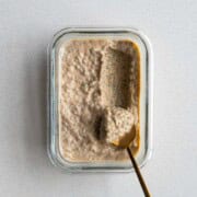 Chia Seed Peanut Butter Pudding in a glass dish with a gold spoon.