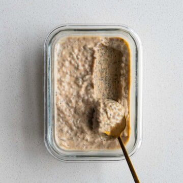 Chia Seed Peanut Butter Pudding in a glass dish with a gold spoon.