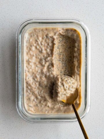 Chia Seed Peanut Butter Pudding in a glass dish with a gold spoon.