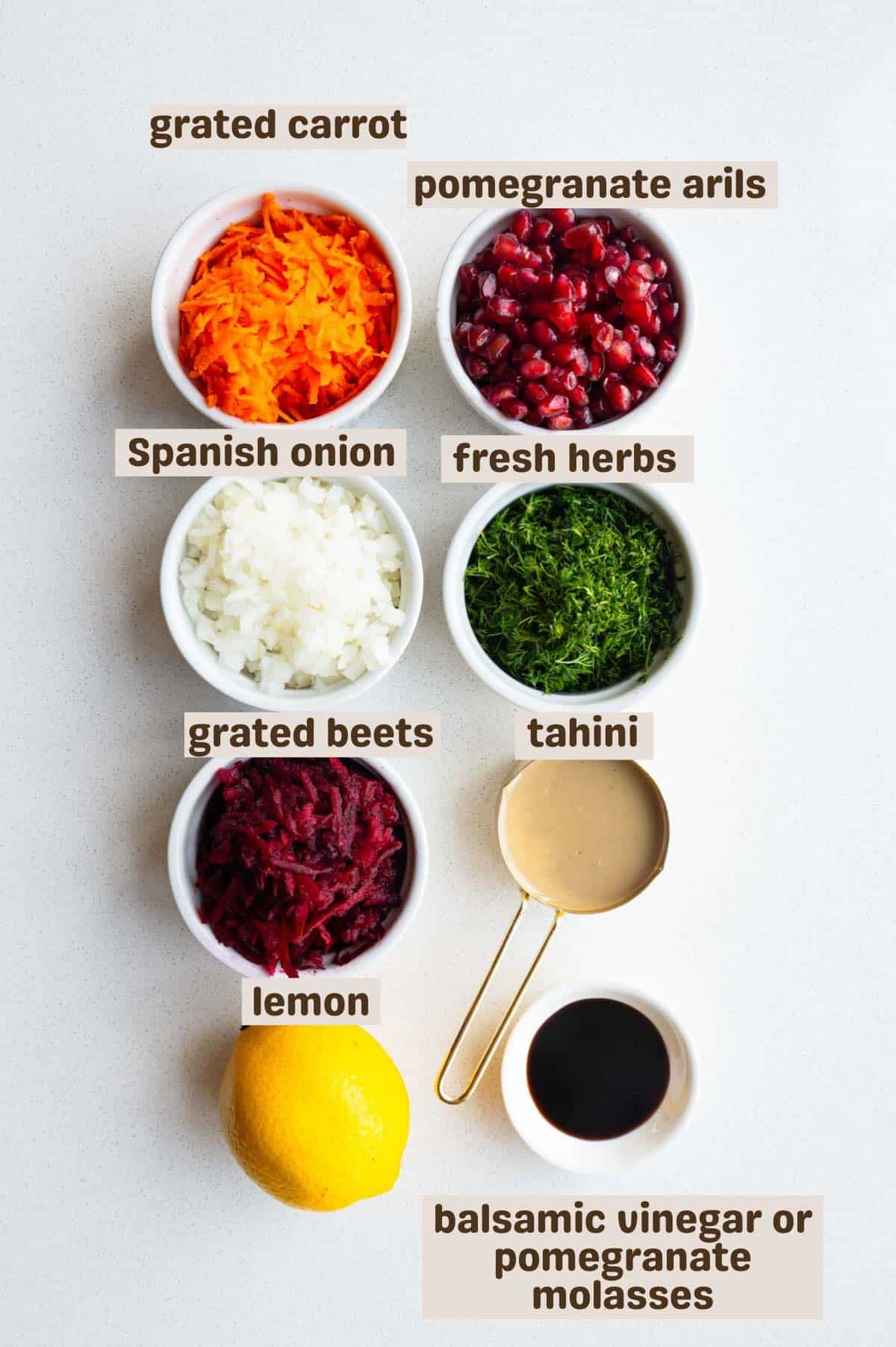 Grated carrot and beets, pomegranate arils, chopped onion and fresh herbs, tahini, lemon, and balsamic glaze or pomegranate molasses.