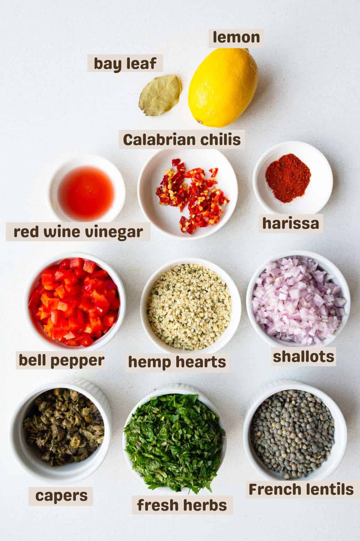 Lentils, chopped bell pepper, fresh herbs, shallots, capers, lemon, hemp hearts, Calabrian chilis, bay leaf, red wine vinegar, and harissa seasoning.