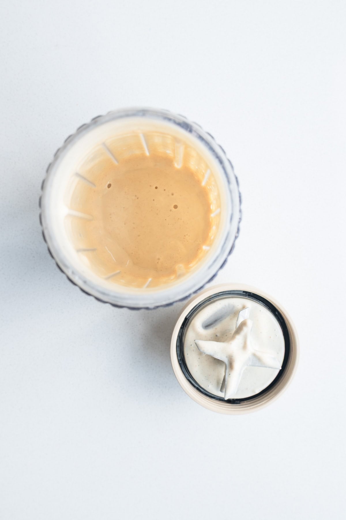 Blended yogurt, nondairy, Medjool dates, lemon zest and juice, dates, tahini, and vanilla blended on the canister of a blender.