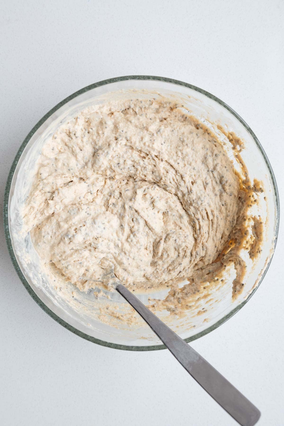 Batter mixed in a bowl with a spoon.