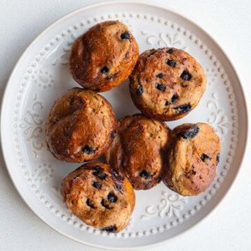 Healthy lemon blueberry muffins with yogurt and chia seeds on a white plate.