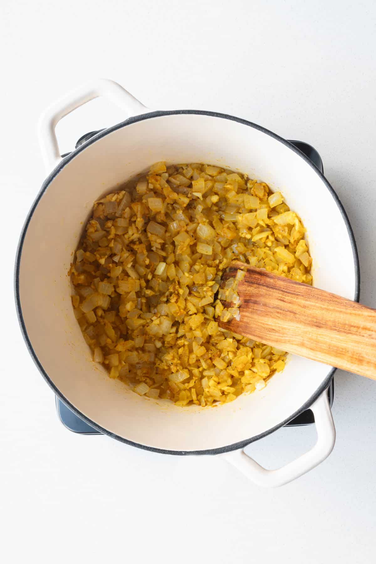 Cooked onion, garlic, and seasonings in a saucepan.