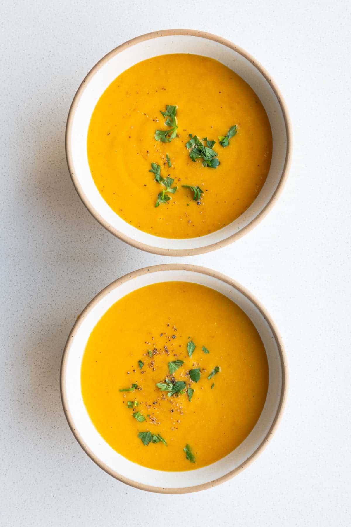 Creamy lentil barley soup in a two bowls.