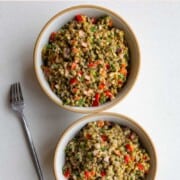 Lentil salad in two bowls with a fork.