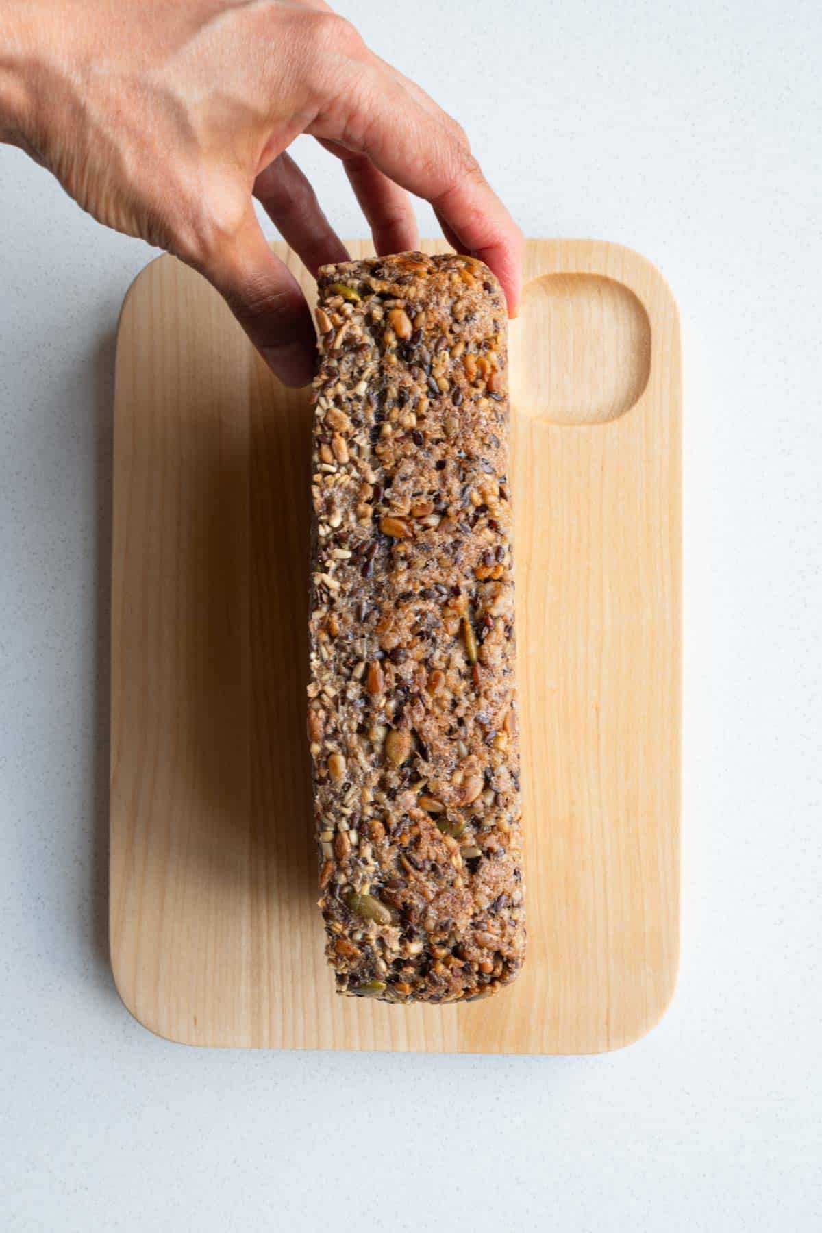 Homemade no yeast bread on a cutting board showing the side view.
