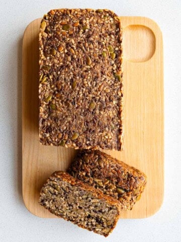Gluten-free Porridge Bread (Seed Bread) made with no yeast sliced on a cutting board.