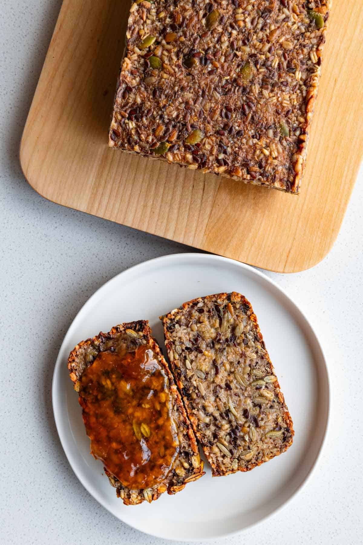 No yeast gluten-free homemade seed porridge bread sliced on a plate with psyllium jelly.