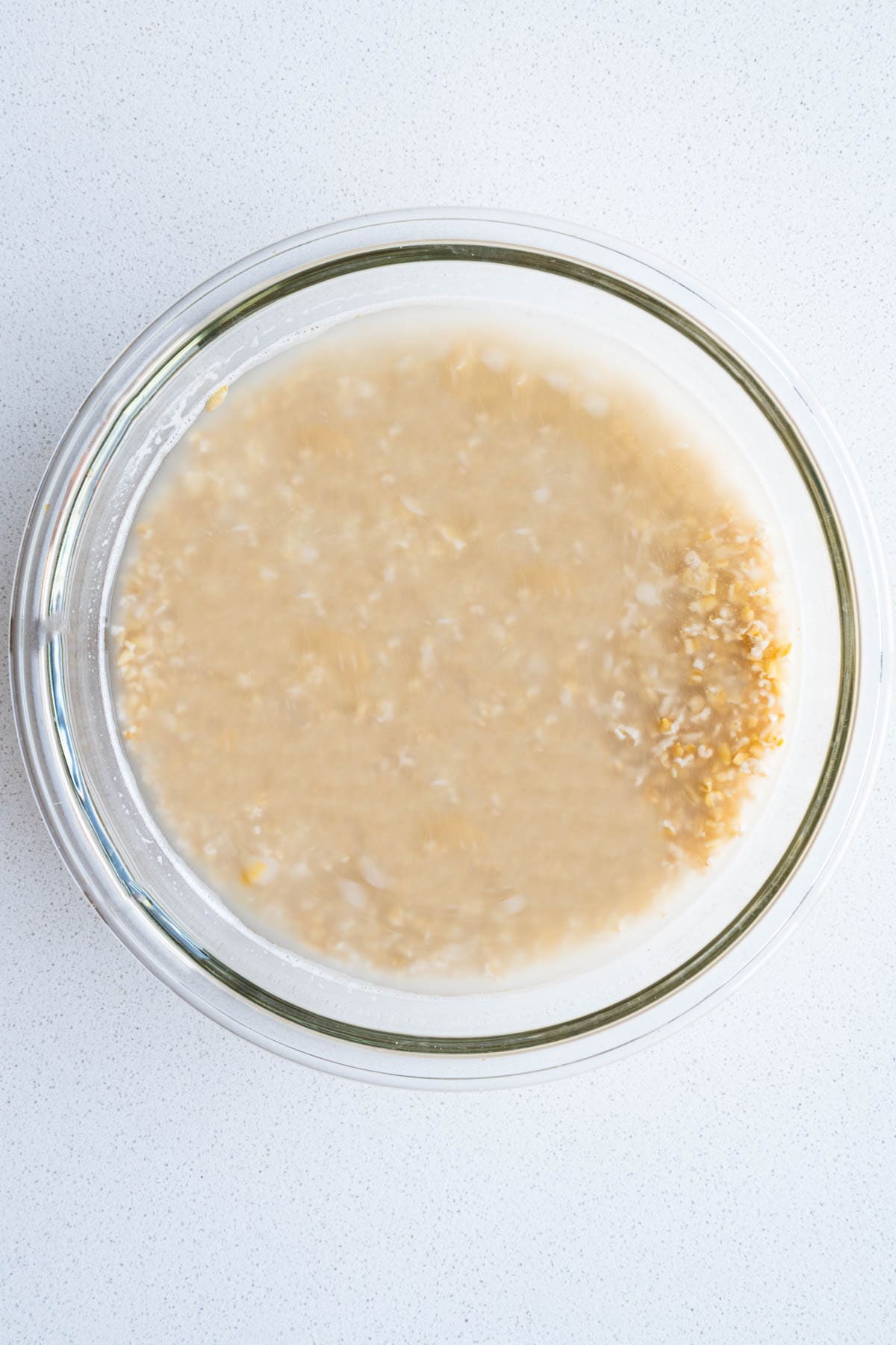 Soaking steel cut oats in a glass bowl.