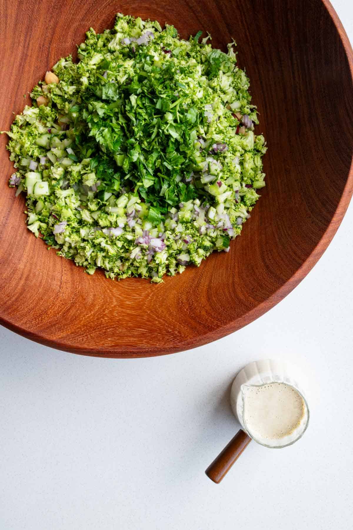 Chopped broccoli, red onion, cucumber, chickpeas, red kidney beans, parsley, coriander, and creamy lime miso dressing.