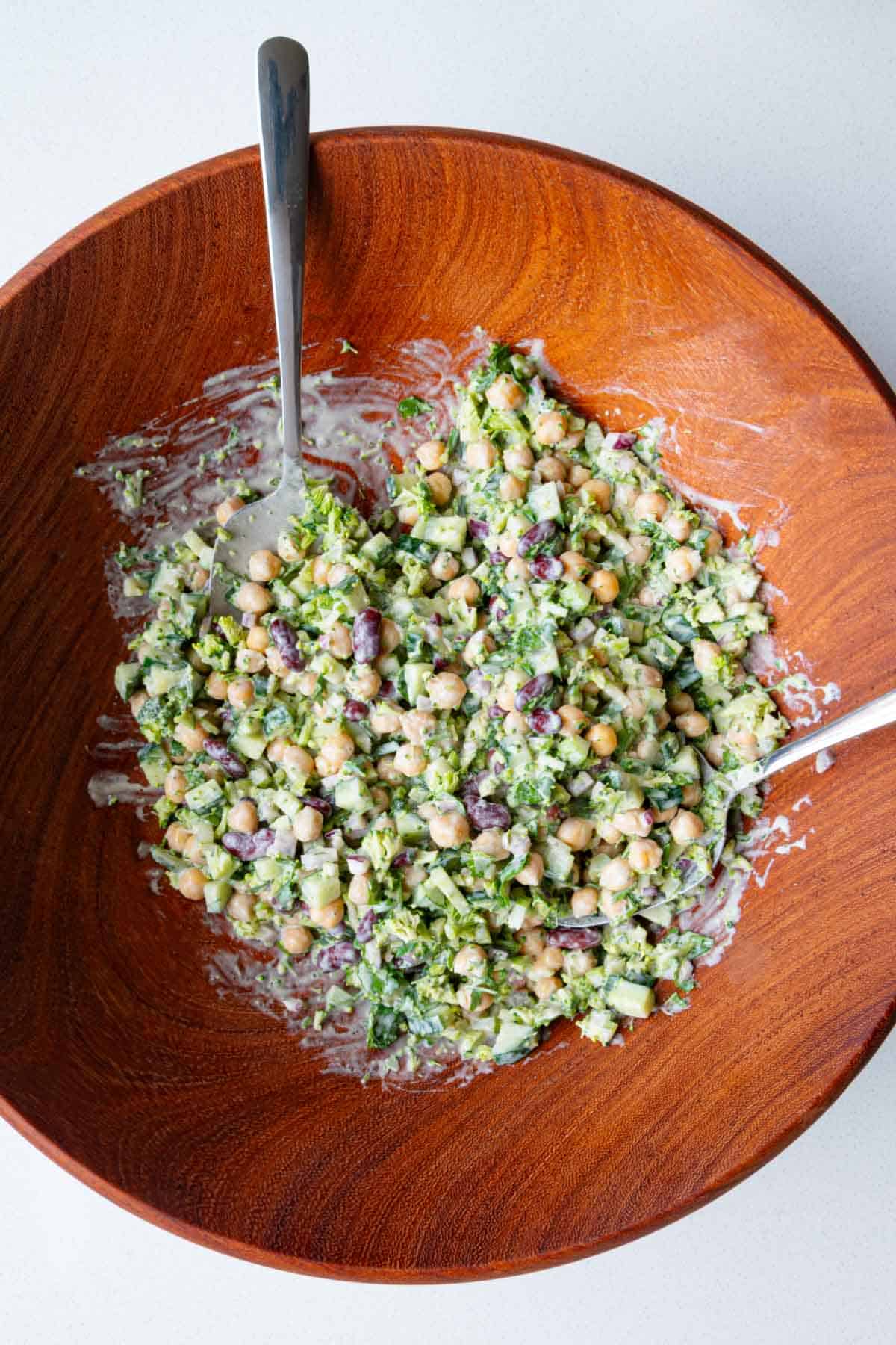 Raw broccoli beans salad in a wooden bowl.