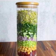 Crunchy Sprouts and Bean Salad with kidney beans, chickpeas, broccoli sprouts, crisp vegetables, and a creamy oil-free lime dressing in a jar.