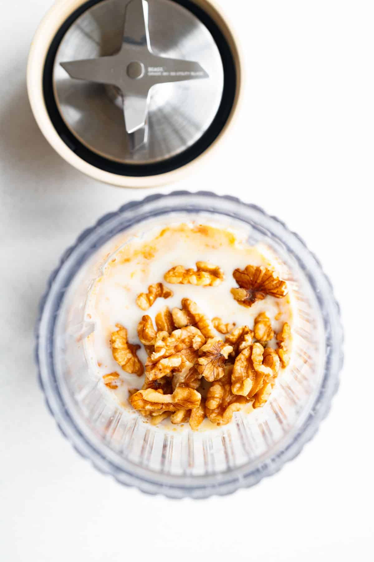 Soaked dates, applesauce, nondairy milk, raw walnuts, and vanilla in the canister of a blender.