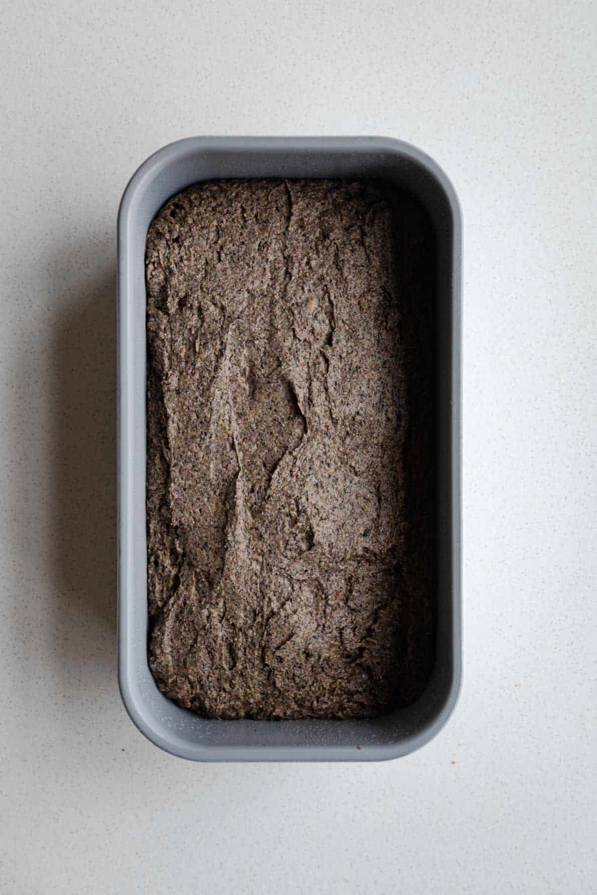Cake batter in a loaf pan.