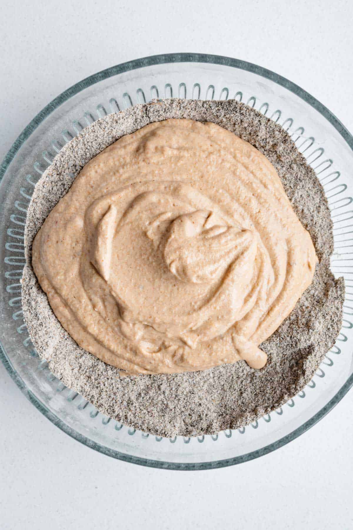 Wet and dry batter in a glass bowl.