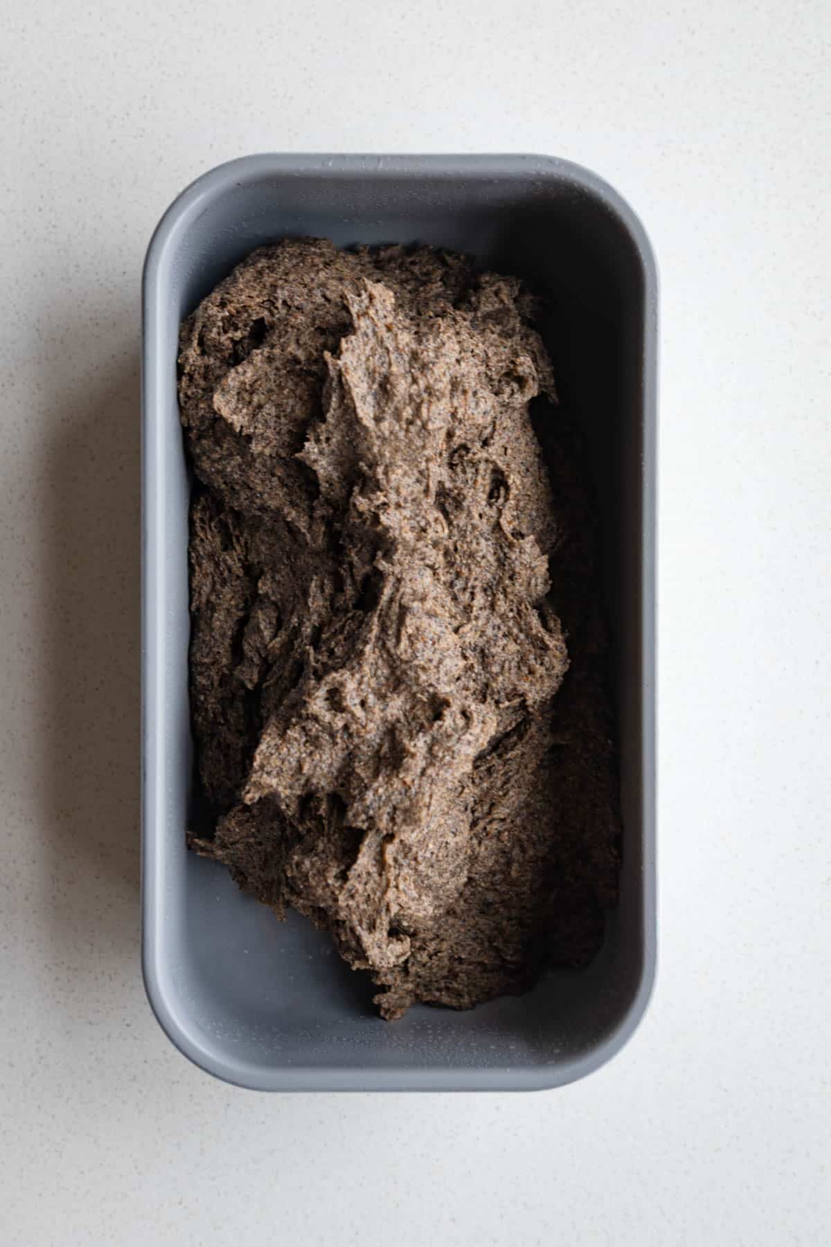 Cake batter scooped into the baking dish.