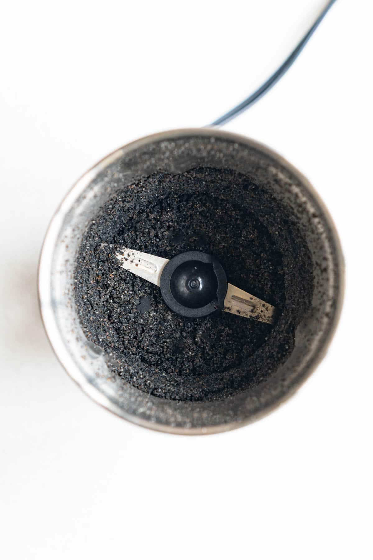 Ground black sesame seeds in a grinder.