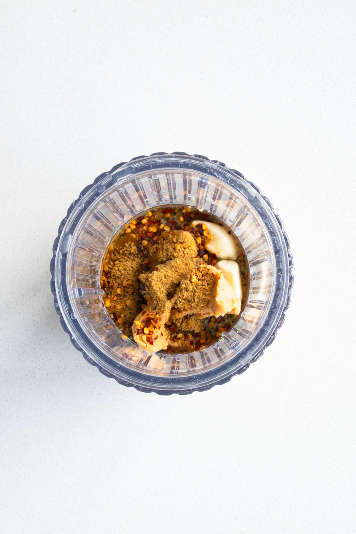 Garlic, crushed red pepper, miso, lime juice and zest, cumin, and dates in a blender.