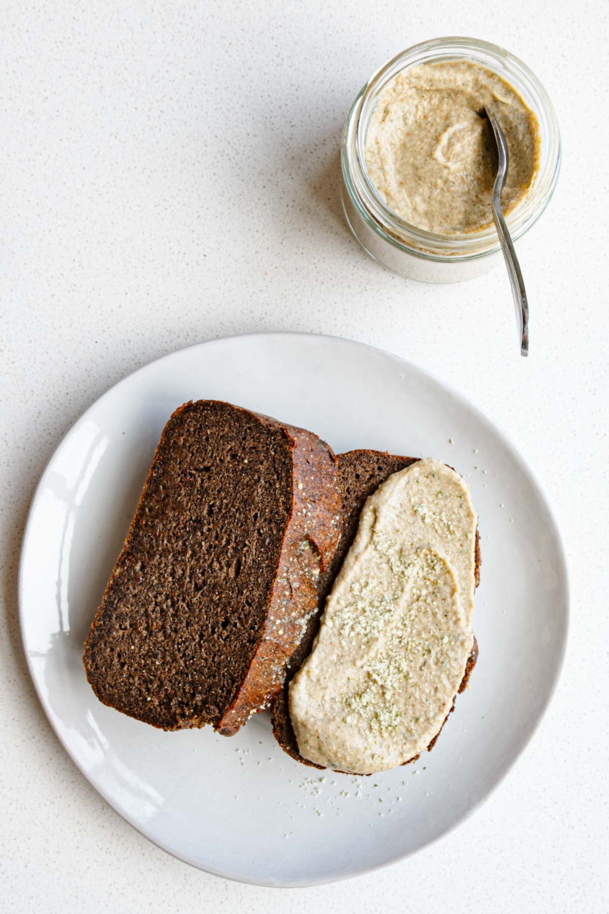 Sweet pumpkin seed butter in a jar and spread onto healthy banana bread.