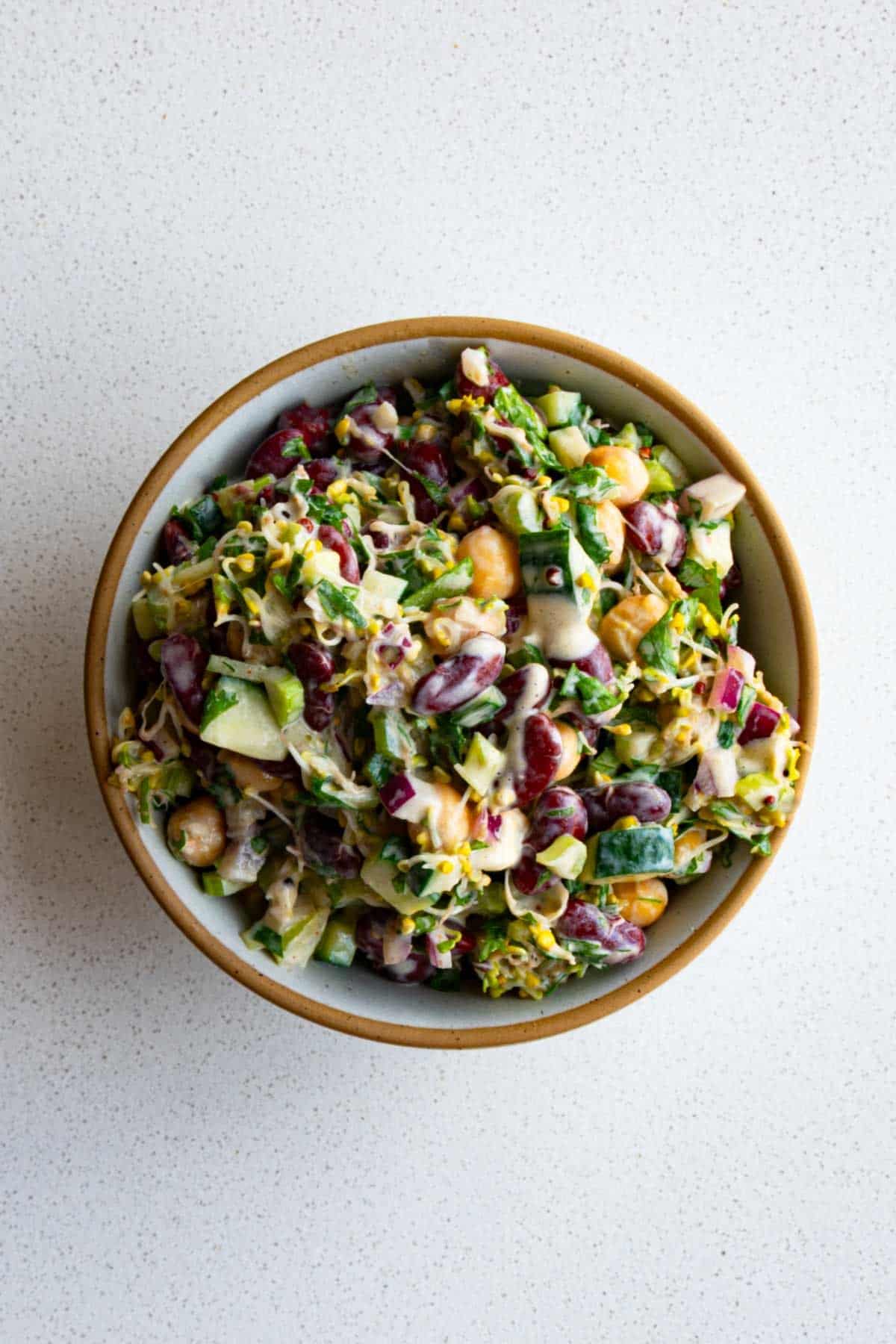 Creamy broccoli and bean salad in a bowl.