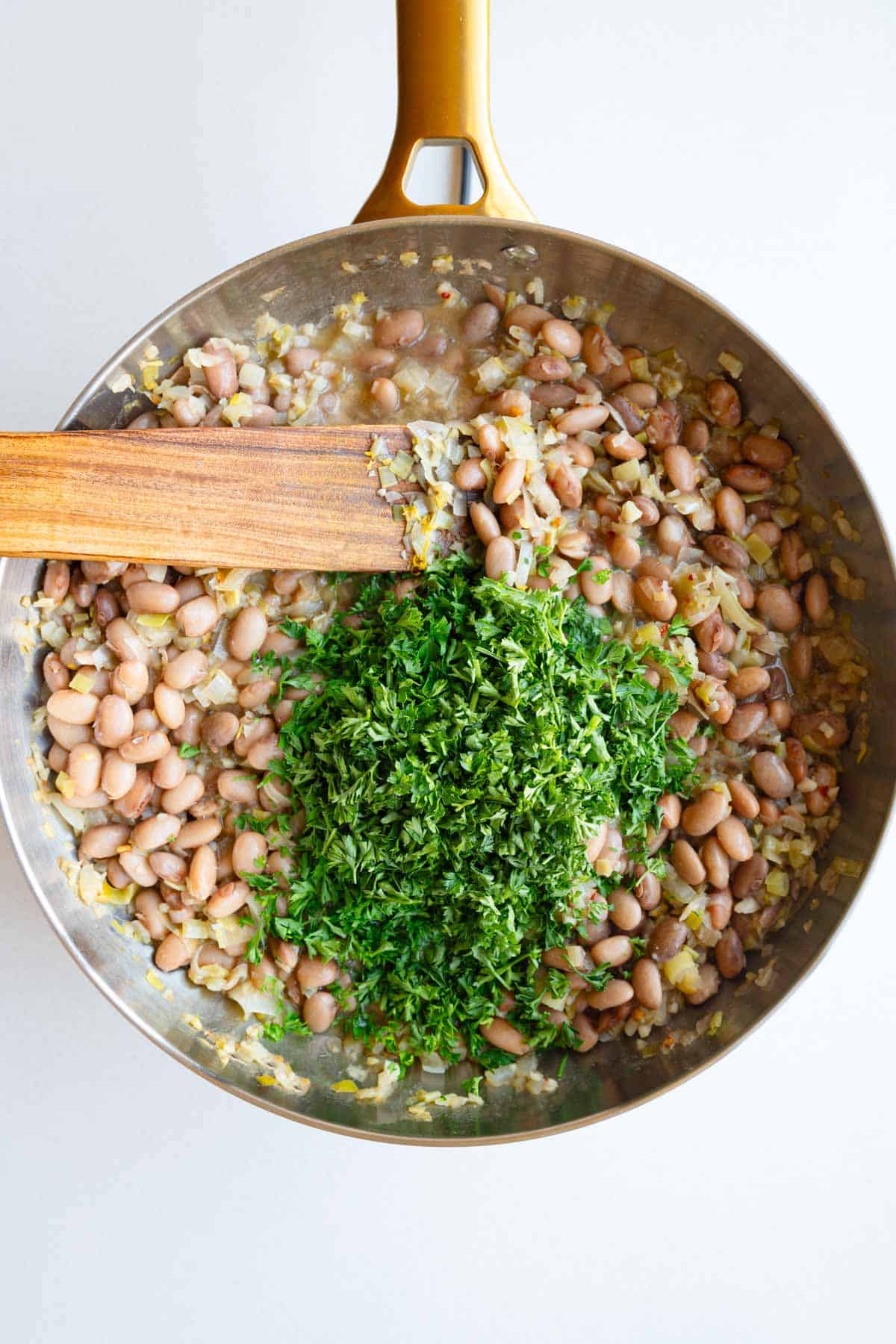 Pinto beans, broth, herbs, cooked leek and onion, and lemon in a large saucepan.