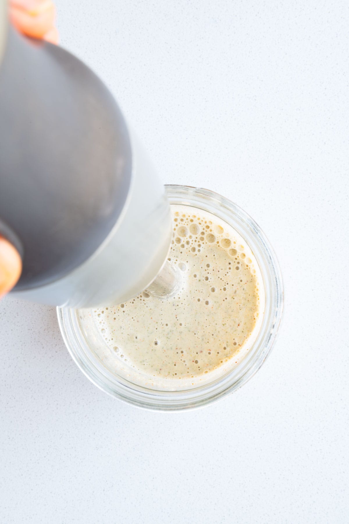 Blending pumpkin seed dressing.