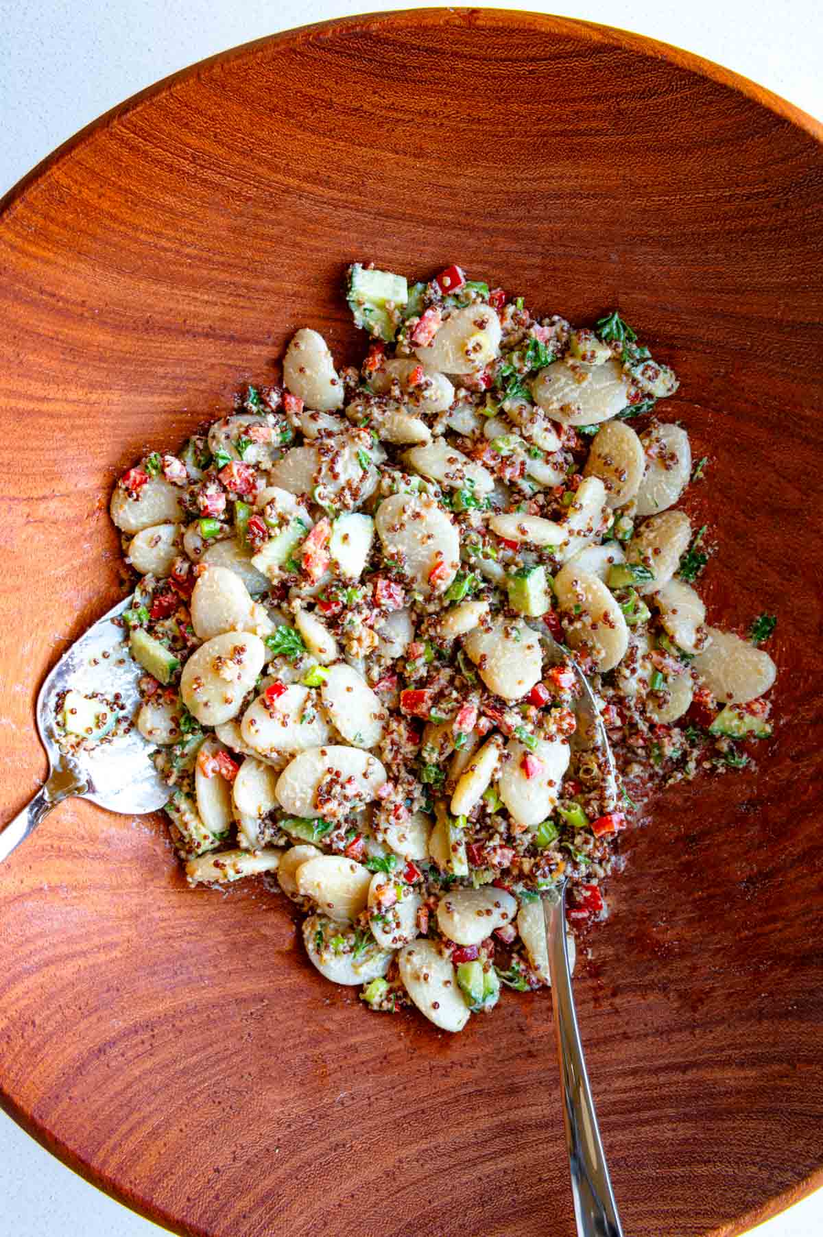 White bean quinoa salad in a wooden bowl.