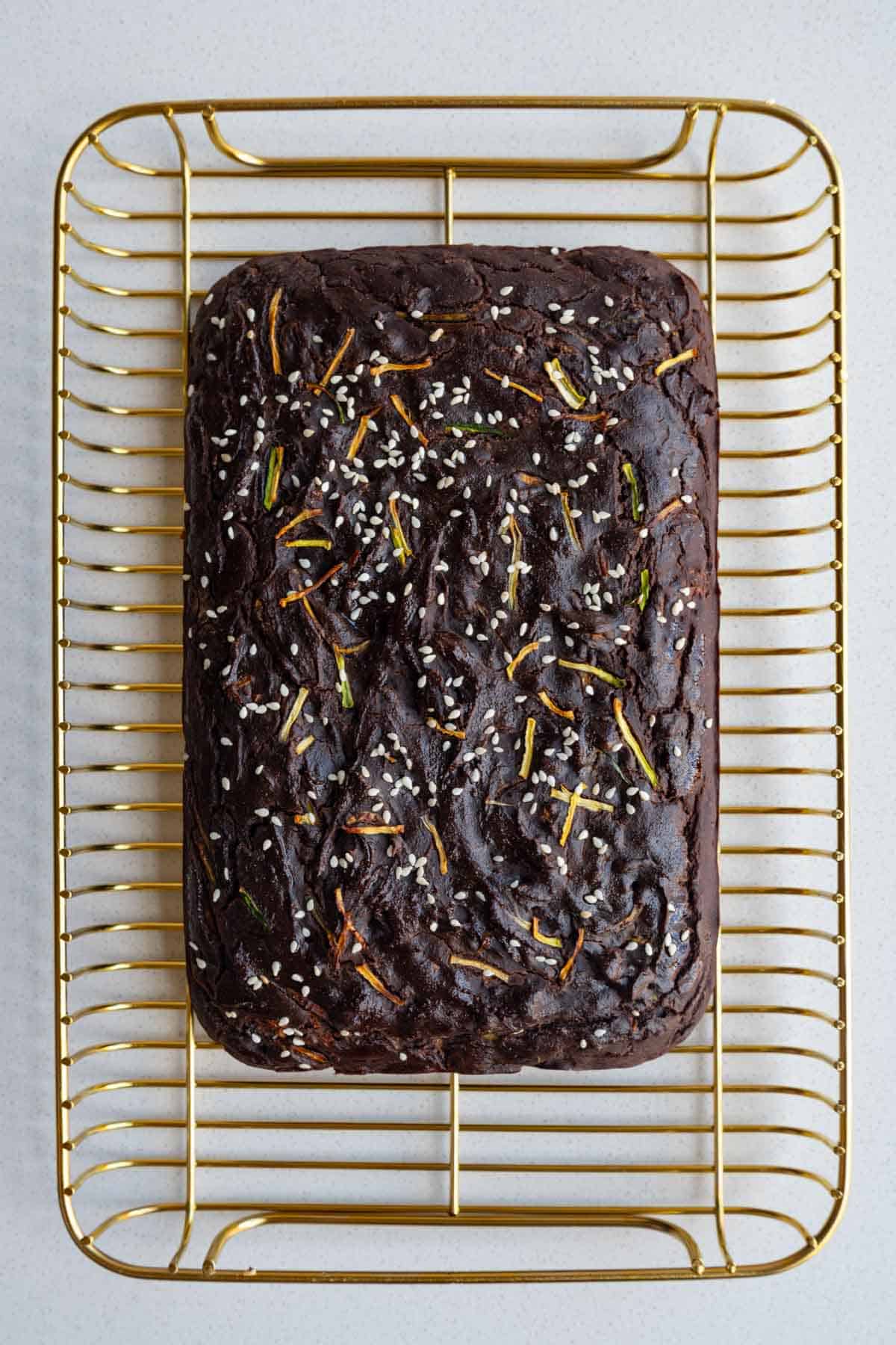 Healthy zucchini chocolate cake on a cooling rack.