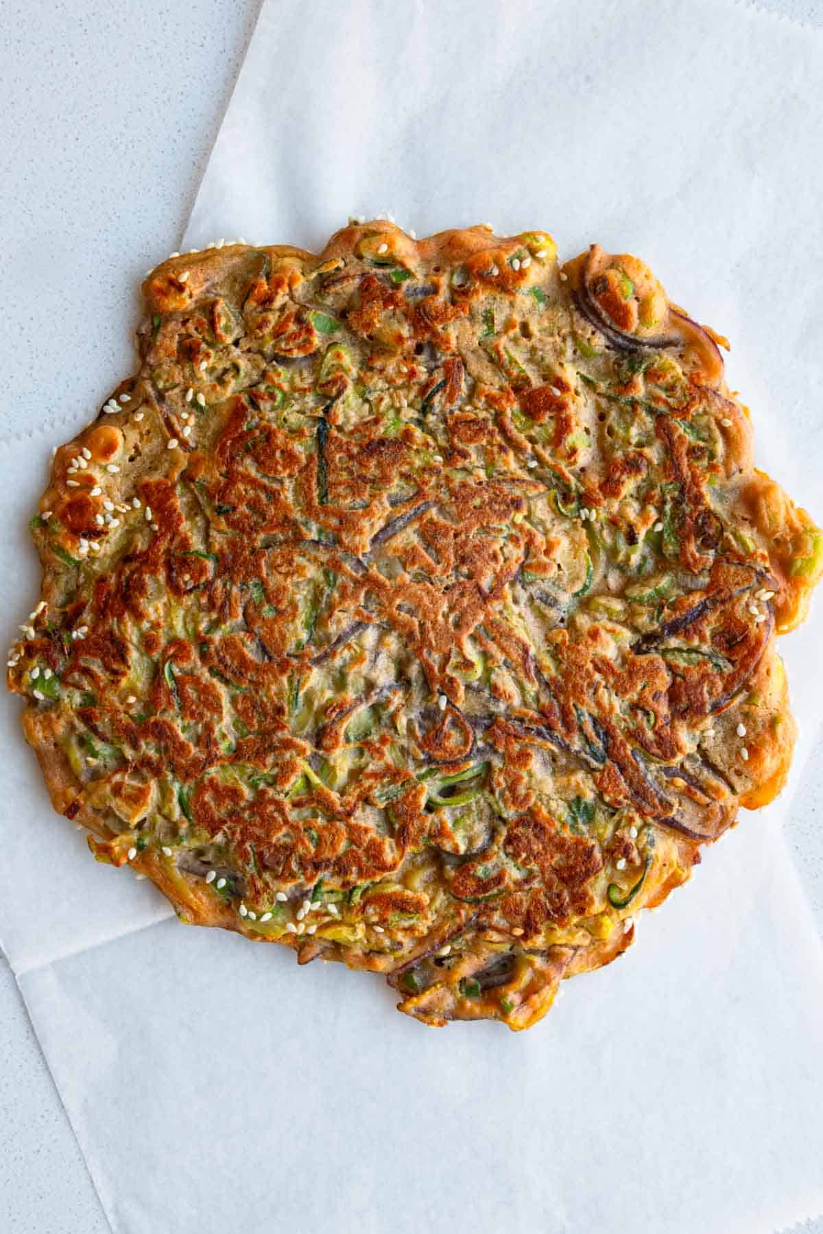 Zucchini pancakes made with red lentils and no flour on parchment paper.