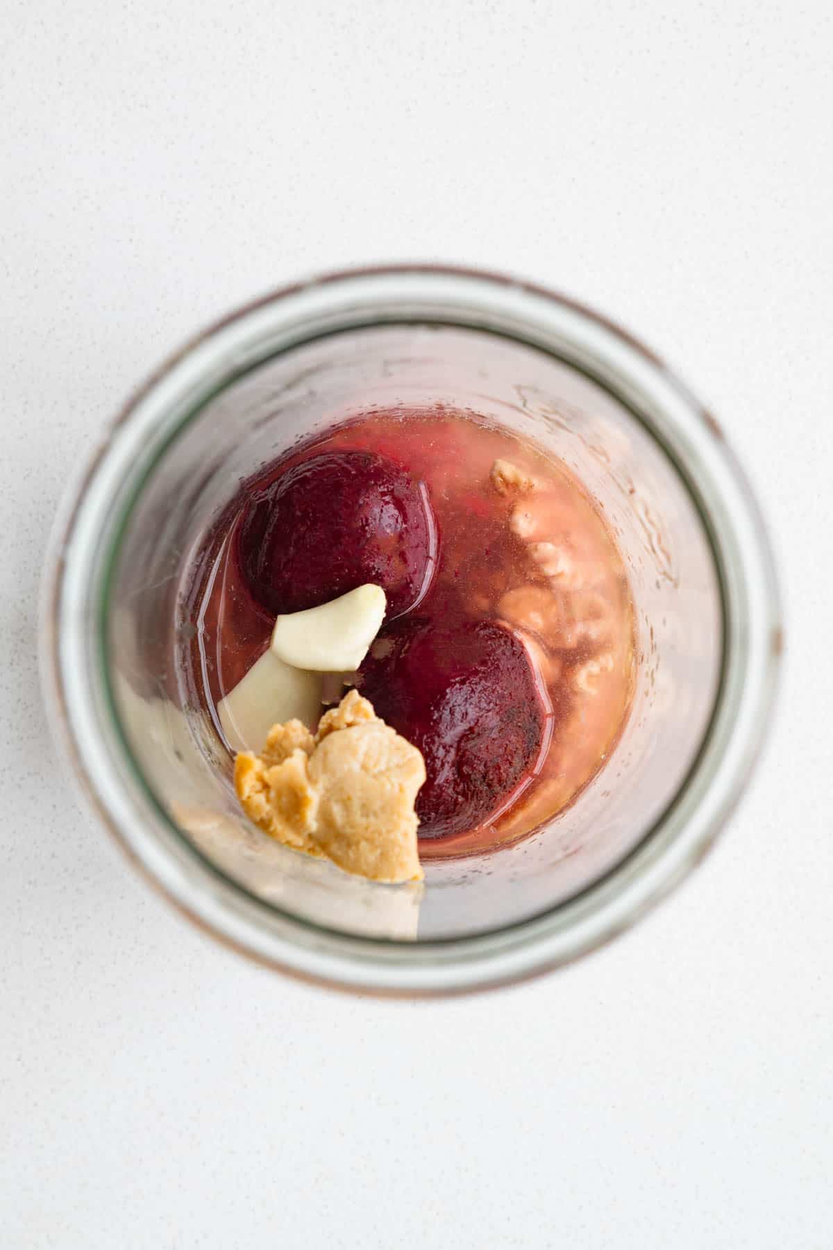 Beets, lemon juice, miso, soaked walnuts, and garlic in a glass jar.