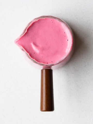 Beet salad dressing in a glass pourer.