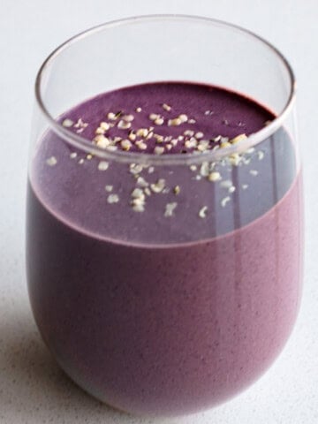Blueberry cocoa smoothie in a glass.