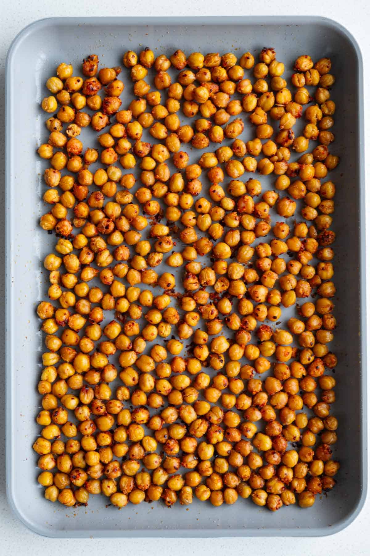 Roasted chickpeas on a baking sheet.