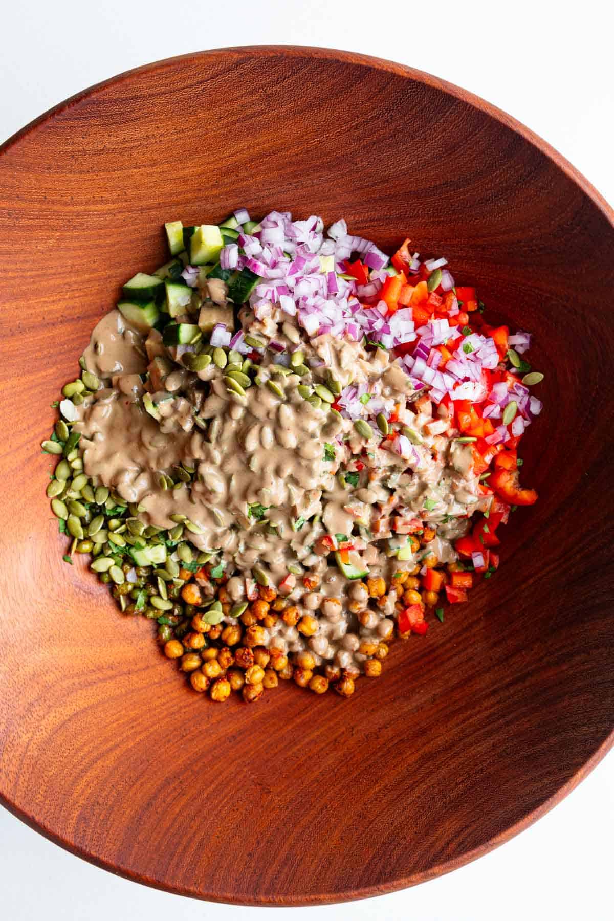 Roasted chickpeas and edamame, chopped red onion, chopped red bell pepper, pumpkin seeds, chopped cucumber, and cilantro with creamy tamarind dressing.