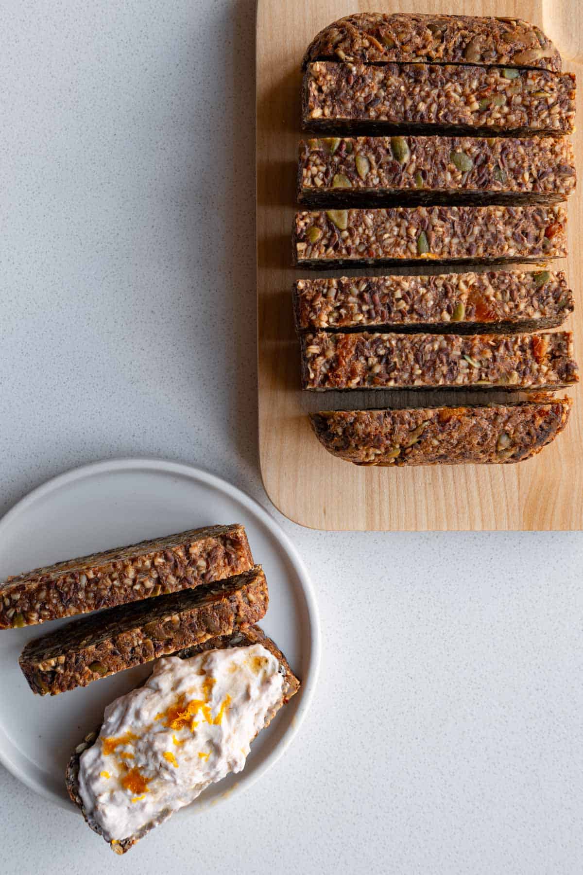 Gluten-free oat bread sliced and topped with tofu cream cheese.