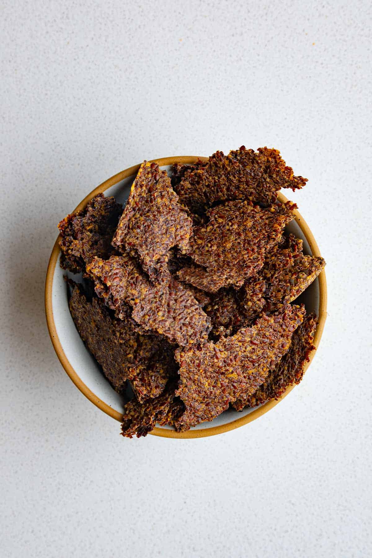Ground flaxseed crackers in a bowl.
