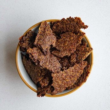 Ground flaxseed crackers in a bowl.