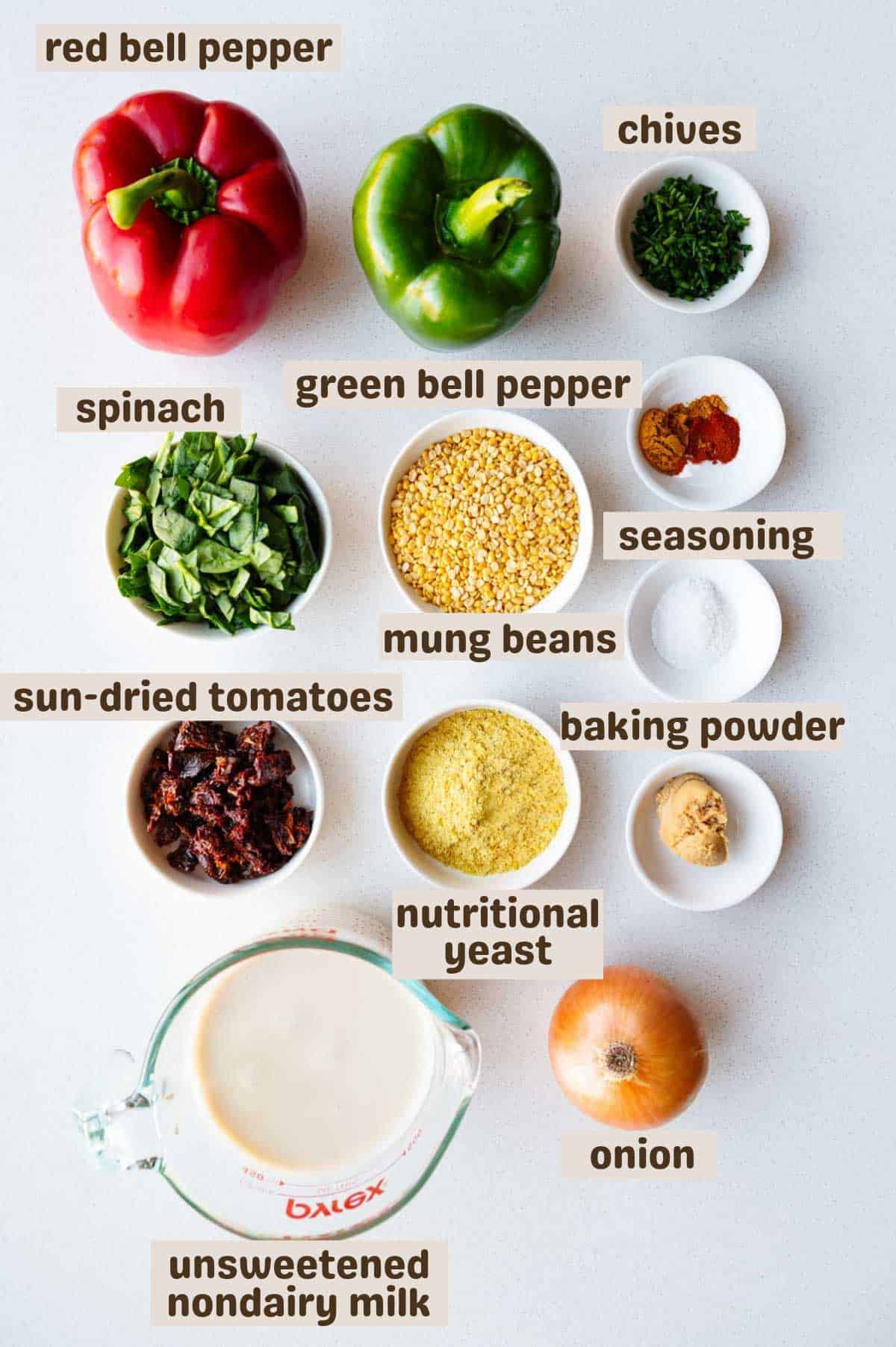 Red and green bell peppers, mung beans (Moong dal), chives, seasoning, onion, baby spinach, nondairy milk, nutritional yeast, miso, and sun-dried tomatoes.