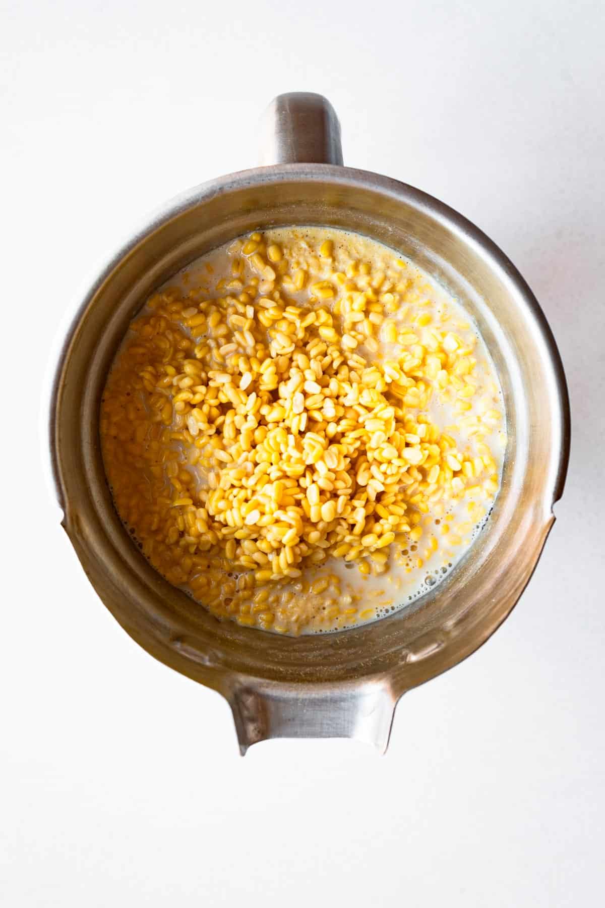 Soaked mung beans, soy milk, low-sodium salt, nutritional yeast, kala namak, turmeric, and miso in a blender.