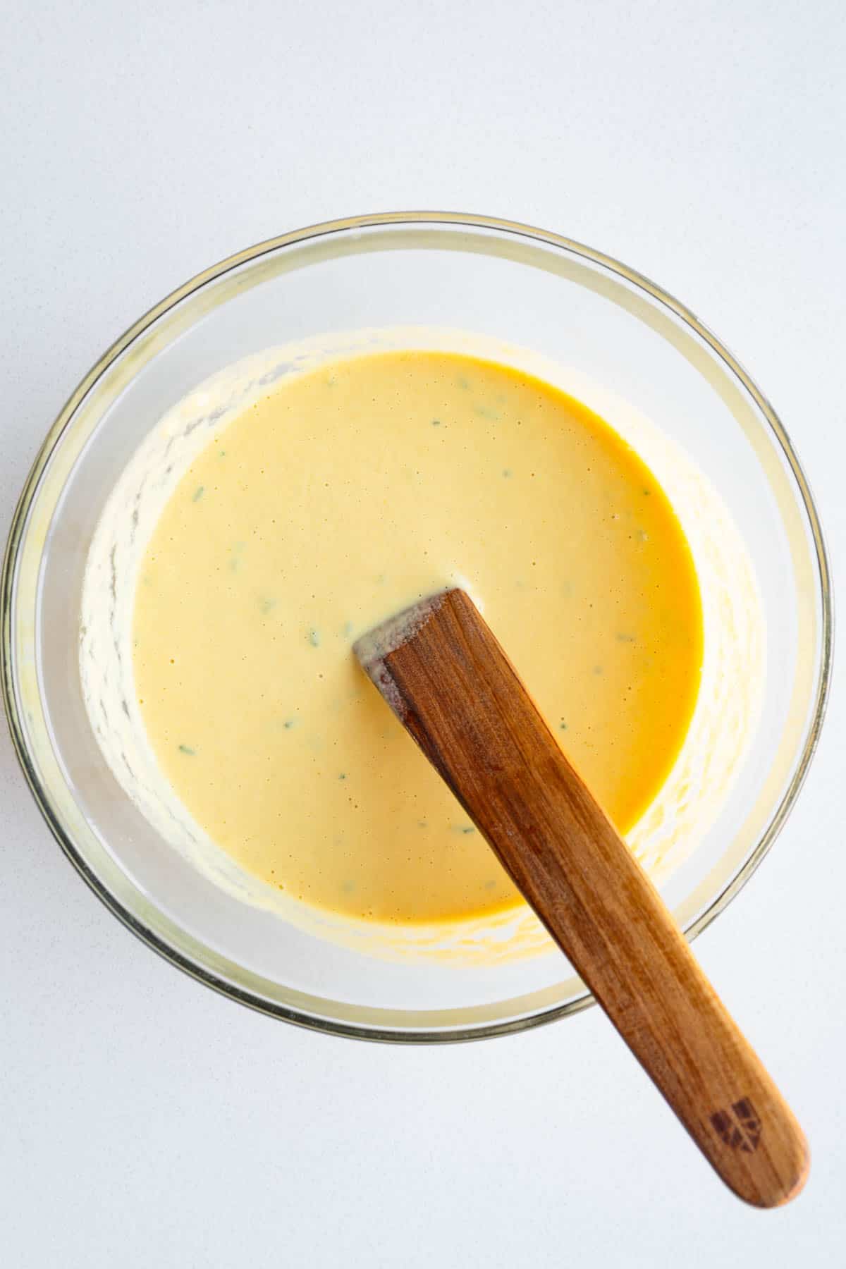Yellow batter in a glass bowl.