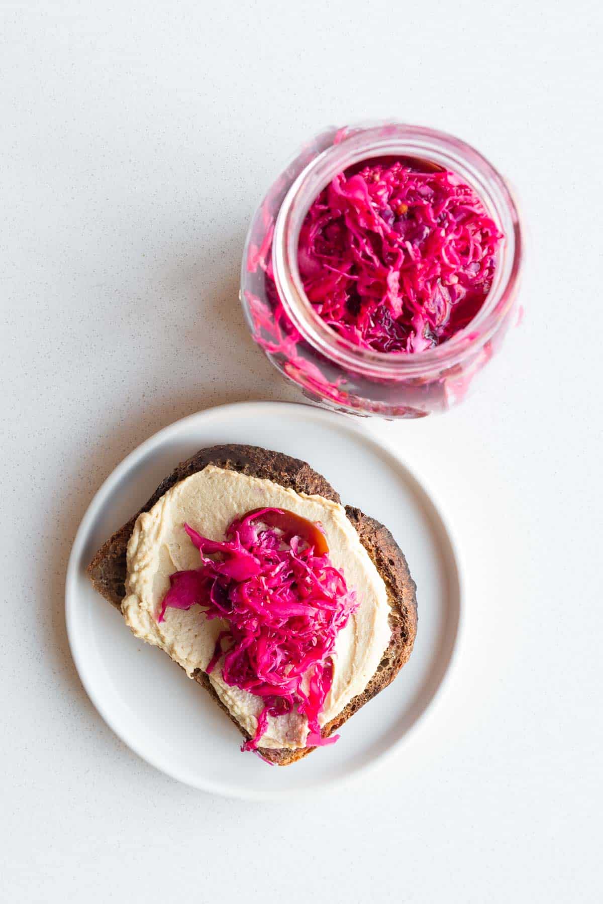 Pickled red cabbage on toasted rye bread with hummus.