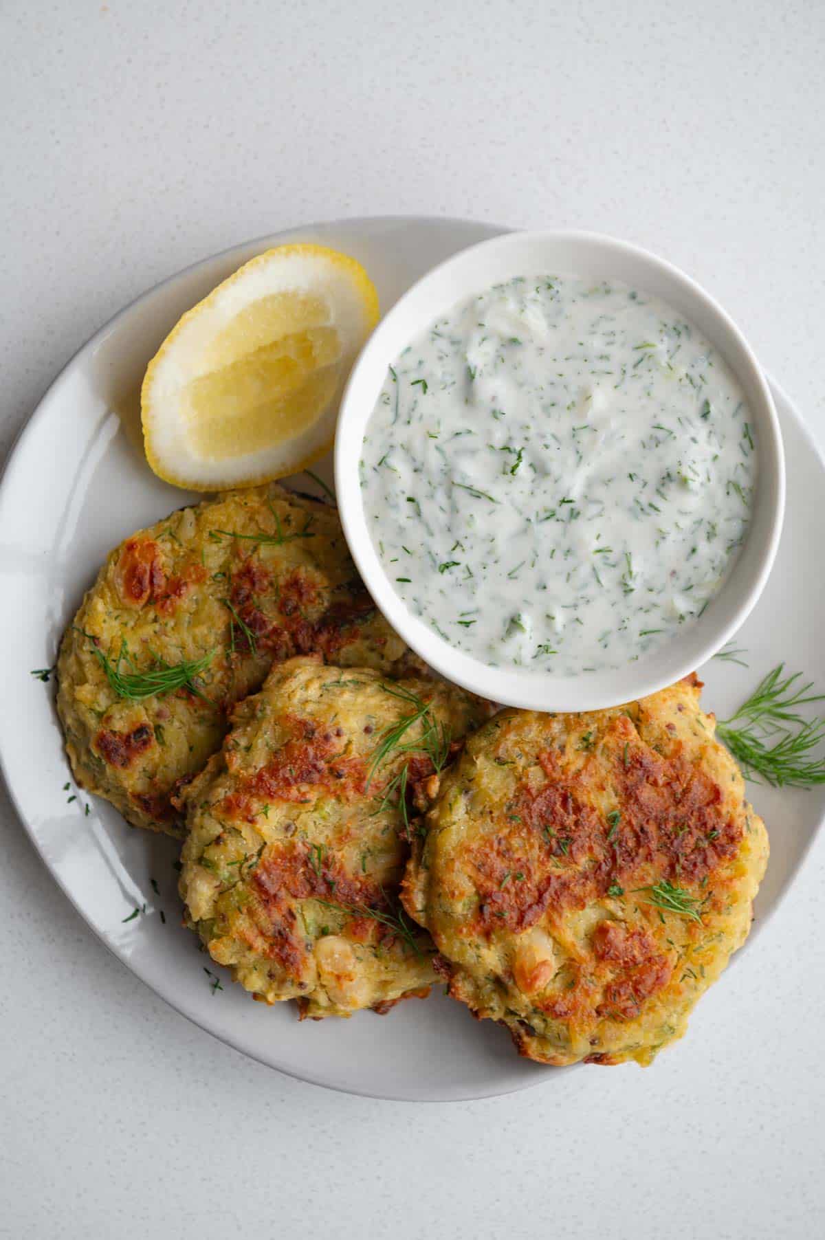 Baked potato fritters with tzatziki sauce.